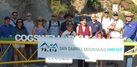 Rep. Chu Holding A "San Gabriel Mountains Forever" Sign With Crowd
